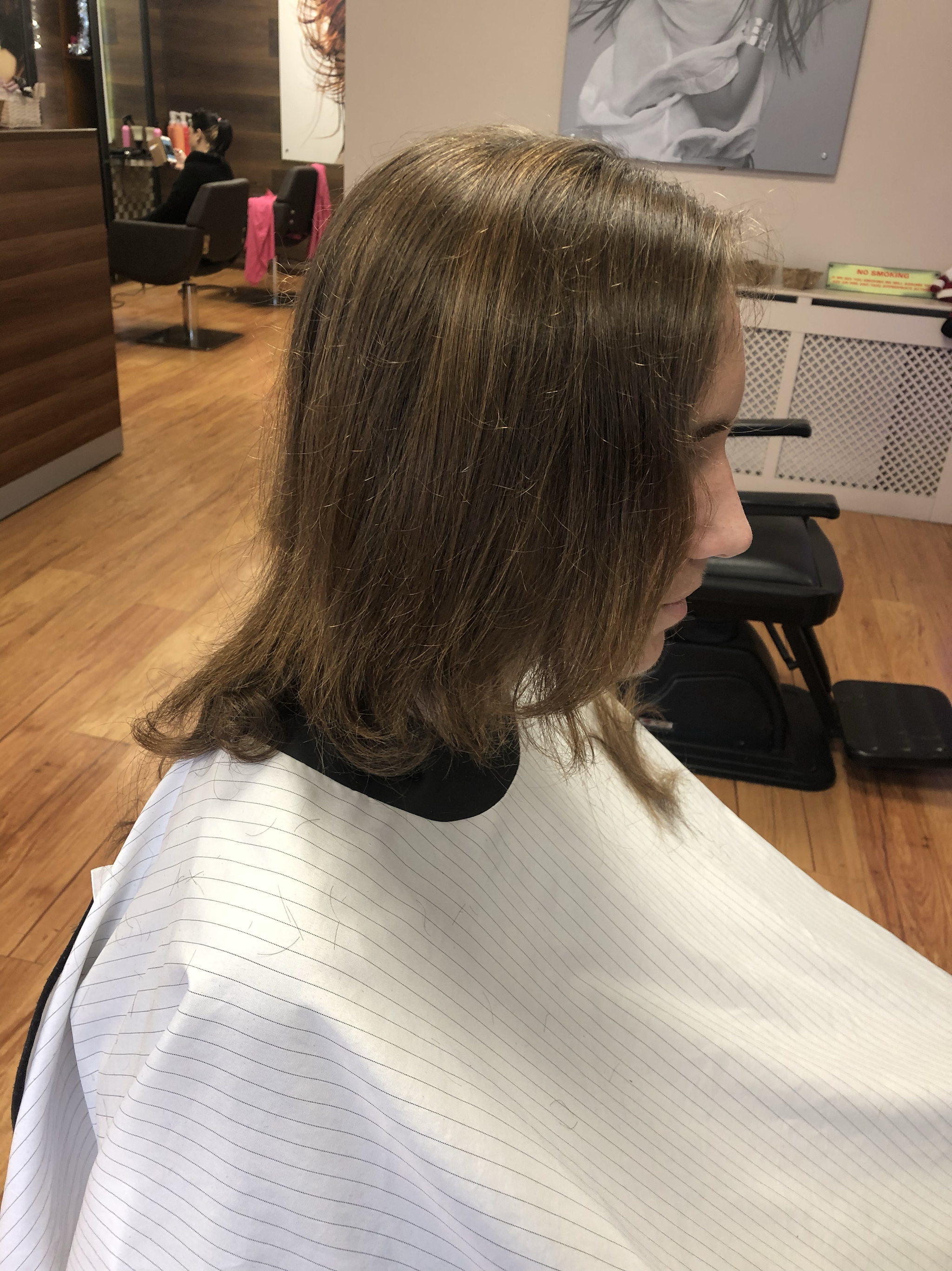 A customer in the chair, ready for a cut