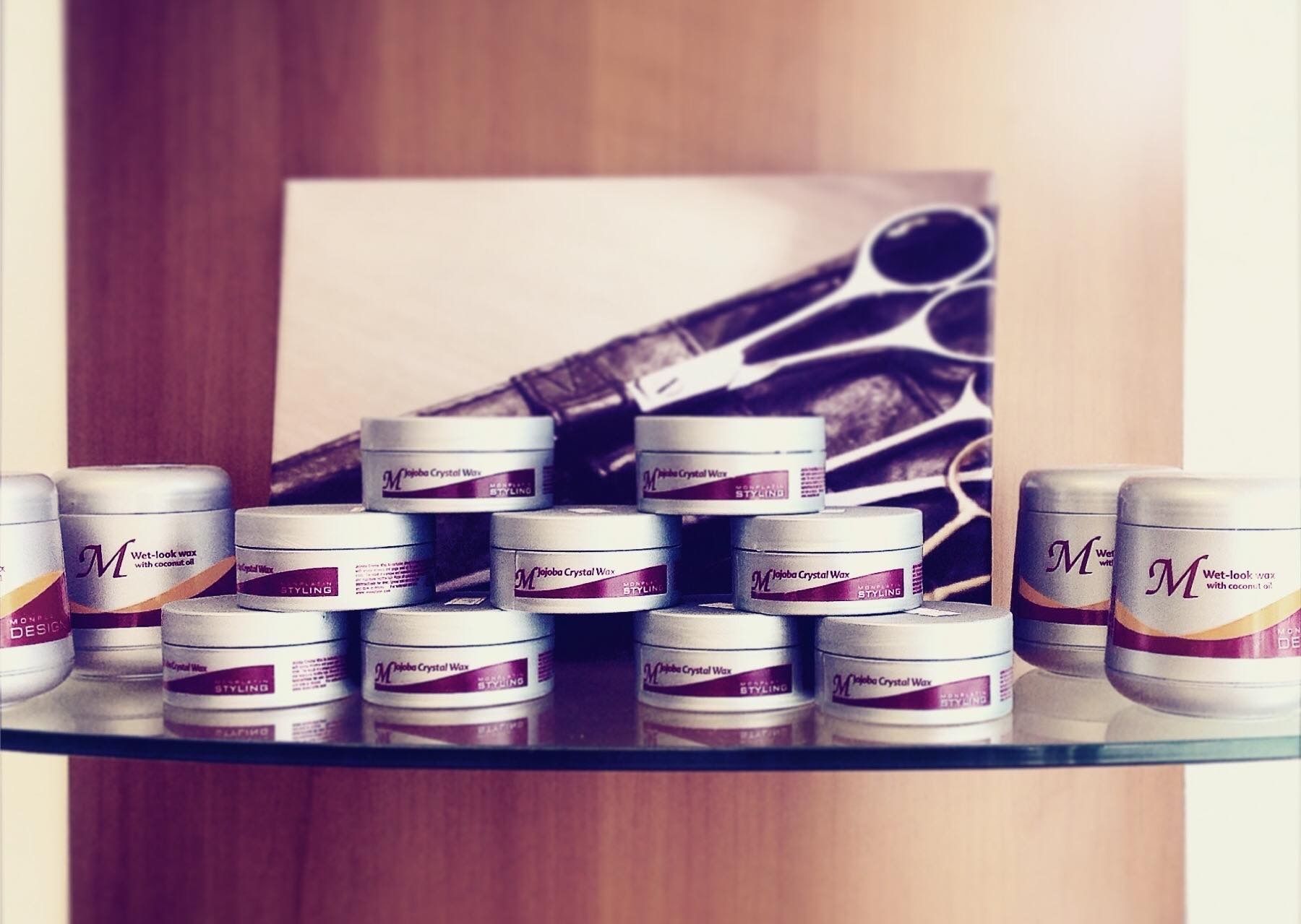 Styling products lined up on a glass shelf